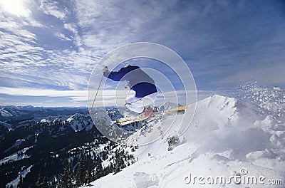 Skier Jumping On Mountain Top Hitting The Slopes Stock Photo