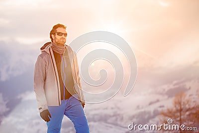Skier man detail wearing anorak jacket with sunglasses portrait. exploring snowy land walking and skiing with alpine ski Stock Photo
