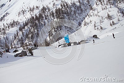 Skier riding a snowkite near to the mountain cabins on Simplon Pass, Switzerland Stock Photo