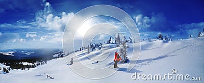 Skier skiing downhill in high mountains against sunset Stock Photo