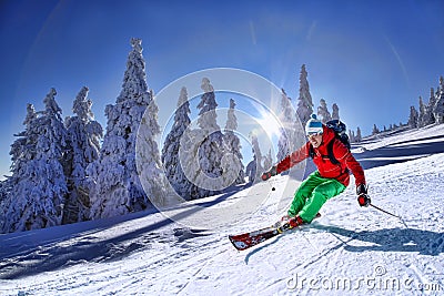 Skier skiing downhill in high mountains Stock Photo