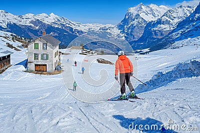 Skier skiing downhill in high mountains Kleine Scheidegg station at Switzerland Editorial Stock Photo