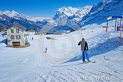 Skier skiing downhill in high mountains Kleine Scheidegg station at Switzerland Editorial Stock Photo