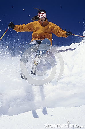 Skier Through Snow Against Blue Sky Stock Photo