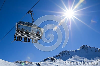 Skiers in a chairlift Stock Photo