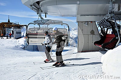Skiers going up with a ski lift in the Alps Editorial Stock Photo