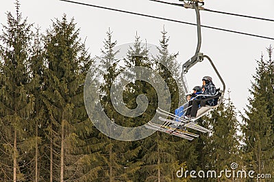 Skiers ride on a lift to the mountain for the descent Editorial Stock Photo