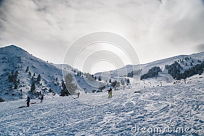 Skiers at snowy ski slope enjoying winter holidays at Kalavryta ski Resort in Greece. Stock Photo
