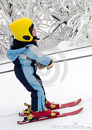 Skiing child on rope lift Stock Photo