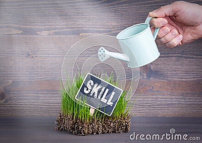 Skill concept. Fresh and green grass on wood background Stock Photo