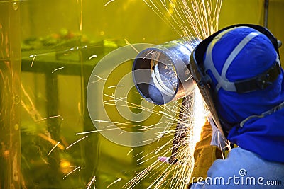The skill worker use hand grinder machine Stock Photo
