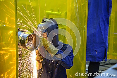 The skill worker use hand grinder machine Stock Photo