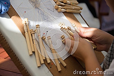 Skilled female hands at the traditional lace making crafts Stock Photo