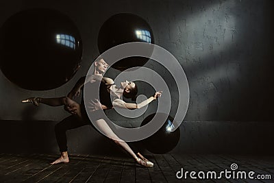 Skilled gymnasts stretching in interaction with each other Stock Photo