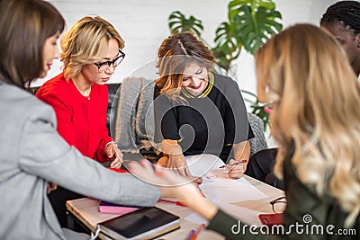 Skilled multicultural female bloggers discussing new themes for media web page. Stock Photo