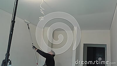 Skilled Worker Paint Ceiling In White Color With Roller Stick Tool