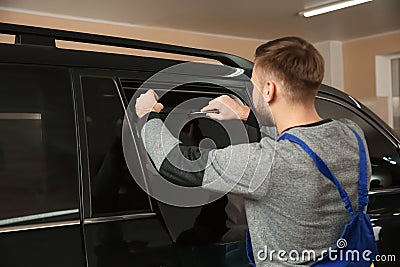 Skilled worker tinting car window Stock Photo