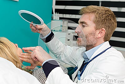 Skillful male dental doctor working with patient Stock Photo