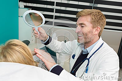 skillful male dental doctor working with patient Stock Photo