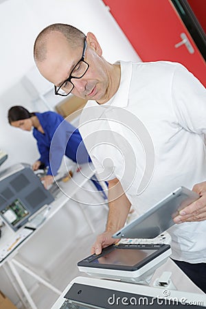 Skillful male engineer using printing Stock Photo