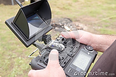 Skillful male freelancer is playing with a drone by remote control Stock Photo