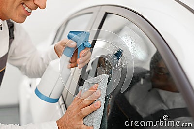 Skillful male technician is cleaning the vehicle Stock Photo