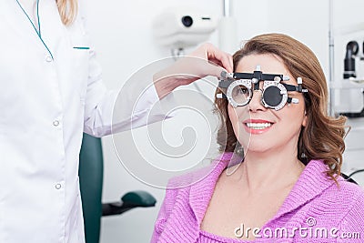 Skillful ophthalmologist with equipment for lens determination Stock Photo