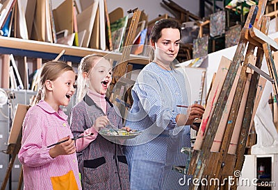 Skillful woman teacher showing her skills during painting class at art studio Stock Photo