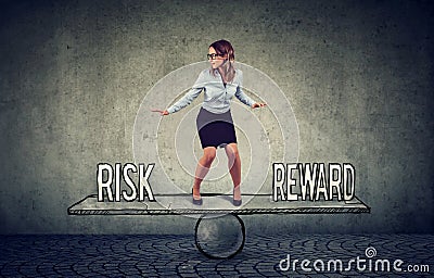 Skillful young business woman balancing between reward and risk Stock Photo
