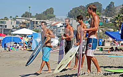 Skim Boarders wait for a wave to ride at Aliso Beach in Laguna Beach, California. Editorial Stock Photo