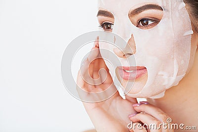 Skin Care. Beautiful girl with sheet mask on her face Stock Photo