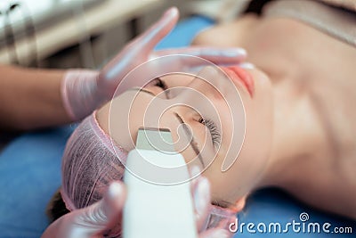 Skin Care. Close-up Of Beautiful Woman Receiving Ultrasound Cavitation Facial Peeling. Ultrasonic Skin Cleansing Procedure. Beauty Stock Photo