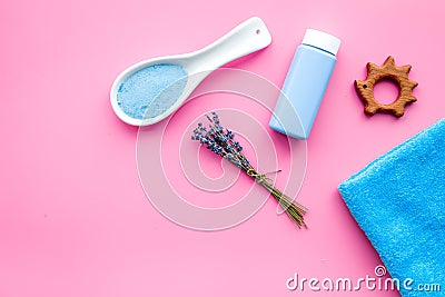 Skin care products for kids with lavender. Bottle, spa salt, towel and toy on pink background top view copy space Stock Photo