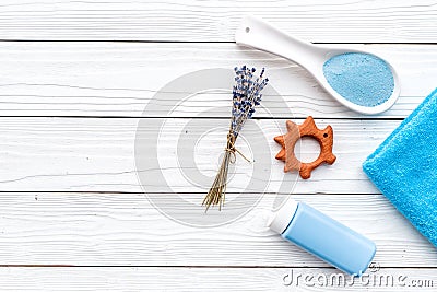 Skin care products for kids with lavender. Bottle, spa salt, towel and toy on white wooden background top view copy Stock Photo