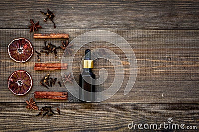 Skin care and relax. Cosmetics and aromatherapy concept. Cinnamon oil on dark wooden background top view copyspace Stock Photo