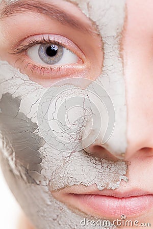 Skin care. Woman applying clay mask on face. Spa. Stock Photo