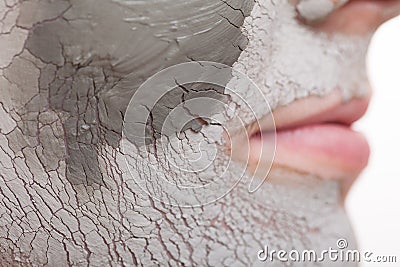 Skin care. Woman applying clay mask on face. Spa. Stock Photo