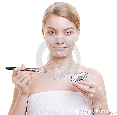 Skin care. Woman applying clay mask on face. Spa. Stock Photo