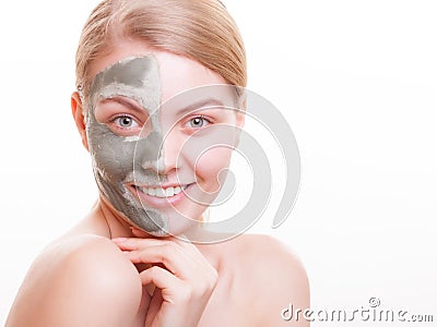 Skin care. Woman applying clay mask on face. Spa. Stock Photo