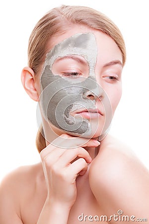 Skin care. Woman applying clay mask on face. Spa. Stock Photo