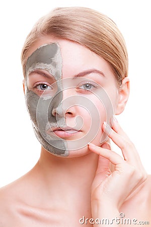 Skin care. Woman applying clay mask on face. Spa. Stock Photo