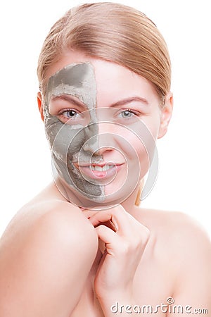 Skin care. Woman applying clay mask on face. Spa. Stock Photo