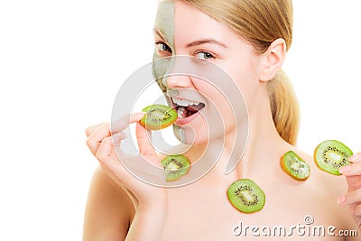 Skin care. Woman in clay mask with kiwi on face Stock Photo