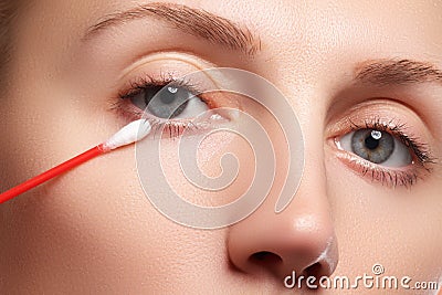 Skin care woman removing face makeup with cotton swab. Skin care concept. Caucasian model with perfect skin. Beauty & Spa. Stock Photo
