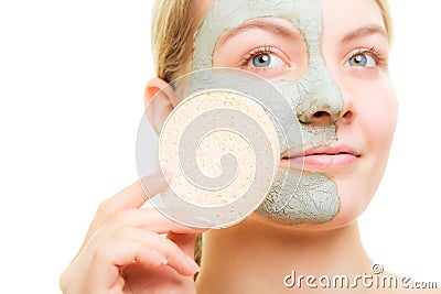 Skin care. Woman removing facial clay mud mask. Stock Photo