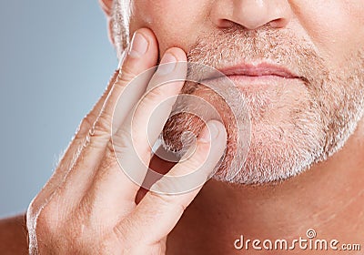 Skincare, beard and mature man in a studio for a hygiene, grooming and cosmetic facial routine. Health, wellness and Stock Photo