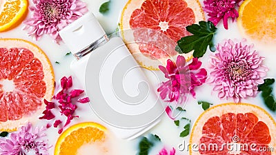 Skincare cosmetic product in milk water with flowers, grapefruit and orange slices. Organic floral or citrus cosmetics. Lotion, Stock Photo