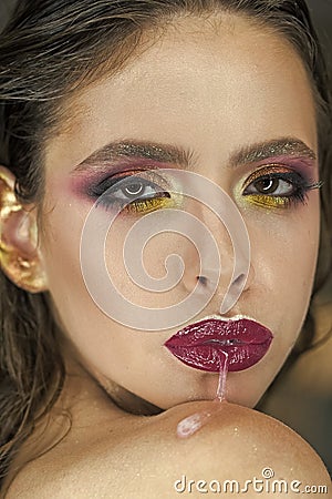 Skincare, cosmetics and visage. Woman run saliva from mouth with purple lips, makeup. Woman with fresh skin face Stock Photo