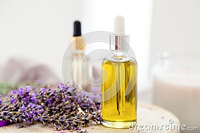 Skincare oil, lavender serum, lavender essential oil. Set lavender bath cosmetics products in bottles with fresh lavender flowers Stock Photo