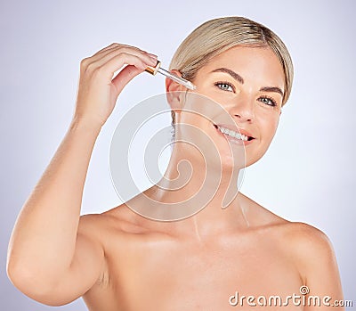 Skincare, portrait and woman in studio for oil, application and hyaluronic acid treatment on grey background. Face Stock Photo